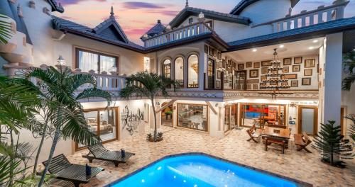 a large house with a swimming pool in the backyard at POTTERLAND Luxury Pool Villa Pattaya Walking Street in Pattaya South