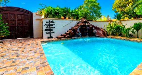 a swimming pool with a water park at POTTERLAND Luxury Pool Villa Pattaya Walking Street in Pattaya South