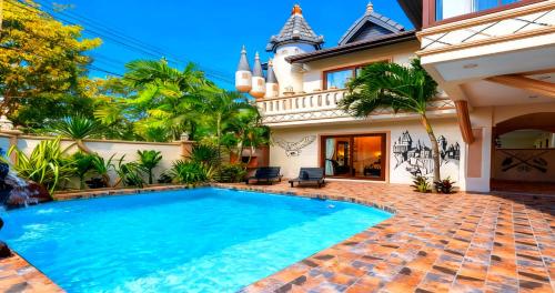 a swimming pool in front of a house at POTTERLAND Luxury Pool Villa Pattaya Walking Street 6 Bedrooms in Pattaya South