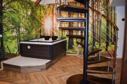 a wellness room with a tree mural on the wall at Apartament w Tucholi in Tuchola