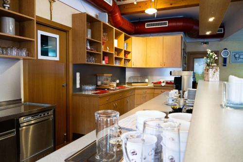 a kitchen with a counter with glasses on it at Gästehaus Ehweiner in Pöls