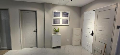 a room with two white closets and a refrigerator at ICB Suites in Tagbilaran City