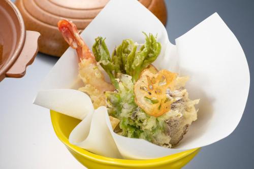 a bowl of food with shrimp and vegetables in it at 料理自慢の温泉宿せせらぎ荘 in Chichibu