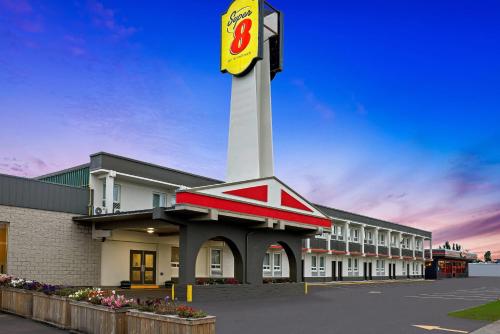 a building with a clock tower in a parking lot at Super 8 by Wyndham Thunder Bay in Thunder Bay