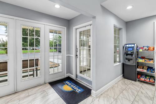 a soda machine in a room with windows at Days Inn by Wyndham Simpsonville in Simpsonville