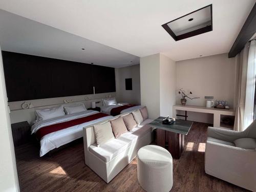 a hotel room with a bed and a couch at Mid Hill White Lodge in Mount Siguniang