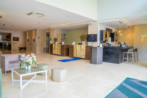 a lobby of a hotel with a reception desk at Wyndham Garden Barranquilla in Barranquilla