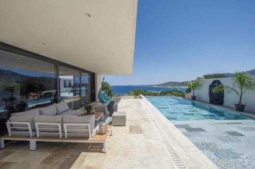 a villa with a swimming pool and a house at Villa Mizar in Algajola