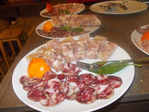 a plate of food on a table with plates of food at Agriturcostabaira in Caltagirone