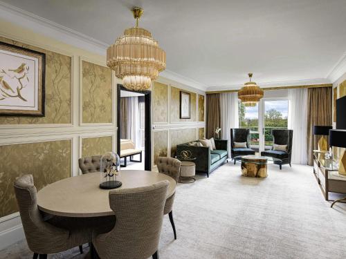 a large living room with a table and chairs at Fairmont Windsor Park in Windsor