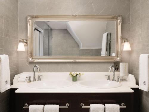a bathroom with a sink and a mirror at Fairmont Windsor Park in Windsor