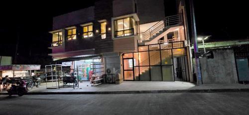 a building on the side of a street at night at ICB Suites in Tagbilaran City