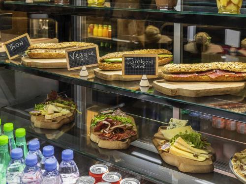 a display case in a store with sandwiches and other foods at ibis Clamart Paris Velizy in Clamart