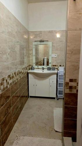 a bathroom with a sink and a mirror at Apartmány Magnólia Štítnik in Štítnik