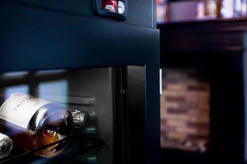 a bottle of wine sitting on top of a microwave at Hotel du Nord, Hamburg-Volksdorf in Hamburg