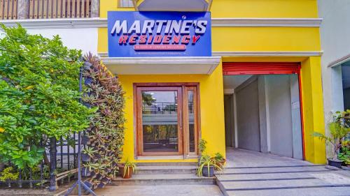 a yellow building with a sign for a restaurant at FabHotel Martines Residency in Puducherry