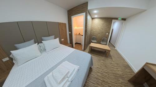 a bedroom with a large bed with white pillows at Mirasierra in Mancha Real