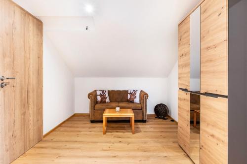 a living room with a couch and a table at Wohnung Staufenblick in Freilassing