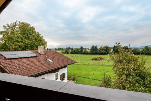 a view of a house with a roof with a field at Wohnung Staufenblick in Freilassing