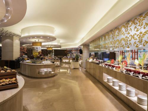 a restaurant with a buffet line of food at Pullman Foshan Shunde-Canton Fair Shuttle Bus at Extra RMB100 per Person Daily in Shunde