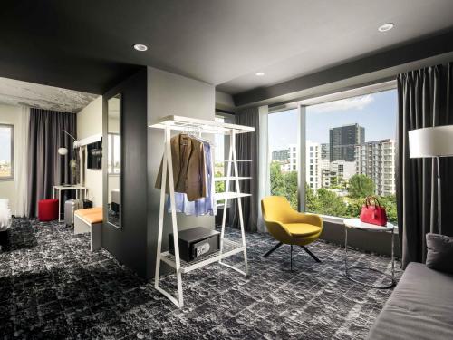 a hotel room with a bedroom with a dressing room at ibis Bucharest Politehnica in Bucharest