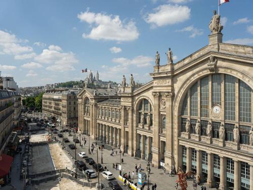 a large building with a street in front of it at 25hours Hotel Terminus Nord in Paris
