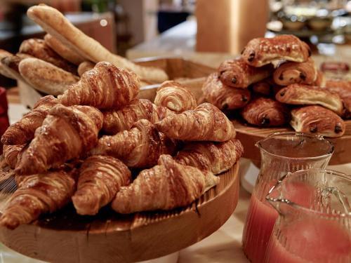 a table with two plates of croissants and other pastries at 25hours Hotel Terminus Nord in Paris
