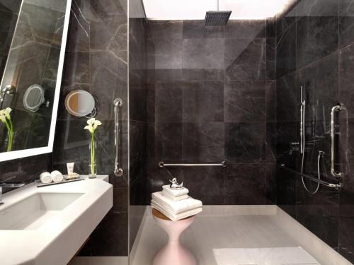 a bathroom with a sink and a toilet and a tub at SLS Dubai Hotel & Residences in Dubai