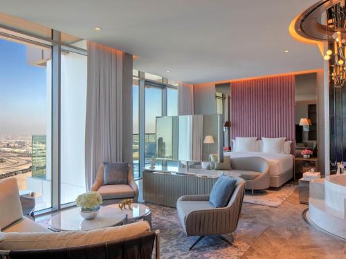 a hotel room with a king bed and a living room at SLS Dubai Hotel & Residences in Dubai