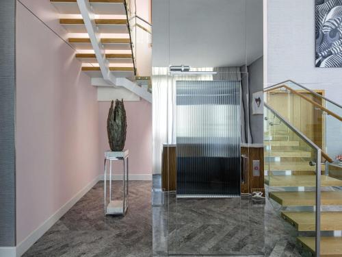 a hallway with stairs and a glass door at SLS Dubai Hotel & Residences in Dubai