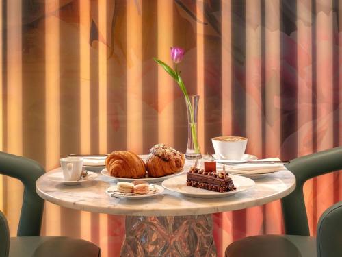 a table with pastries and desserts on a table at SLS Dubai Hotel & Residences in Dubai