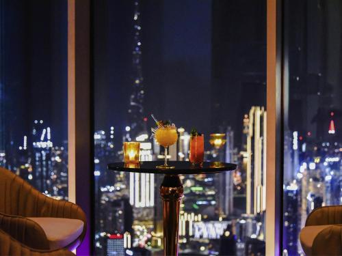 a table with drinks on it in front of a window at SLS Dubai Hotel & Residences in Dubai