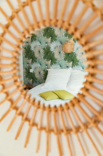 a reflection of a bedroom with a bed in a mirror at Domaine de la Papeterie in Glay
