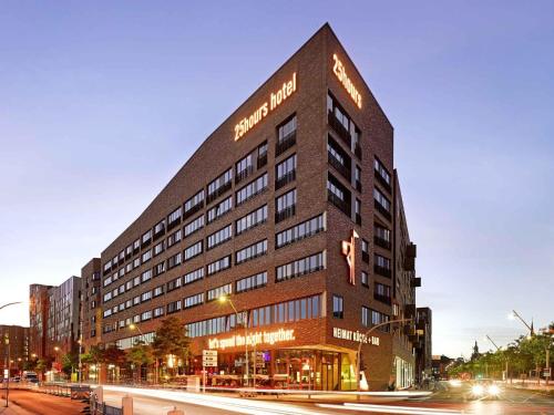 a large building with a sign on the side of it at 25hours Hotel Hamburg HafenCity in Hamburg