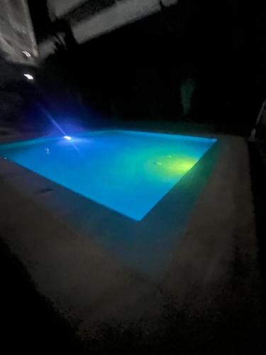 a pool with blue and green lights on it at Habitación en Ph Mistyc Towers in Panama City