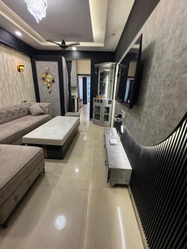 a living room with a couch and a fish tank at A5 tower flat number 708 in Karnal