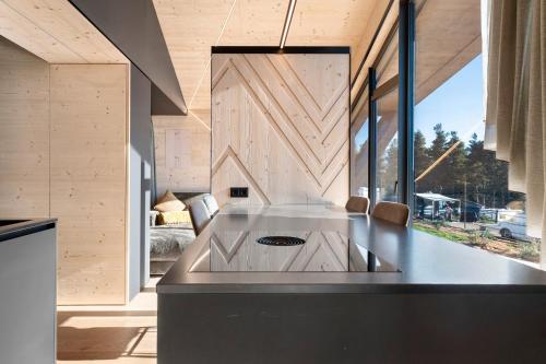 a kitchen with a large island in the middle of a room at Dolomites View X Lodges - Camping in Nova Ponente