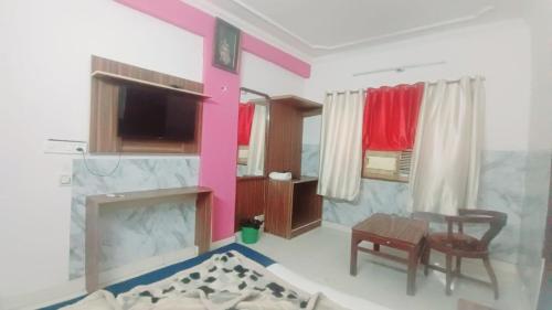 a living room with a table and a fireplace at Hotel M India Dx- NEAR NEW DELHI RAILWAY STATION in New Delhi