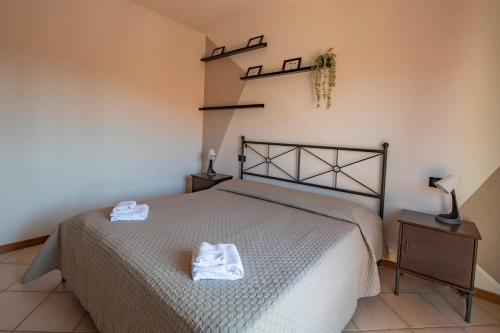 a bedroom with a bed with two towels on it at Cozy Corner near Lucca in Chiesina Uzzanese