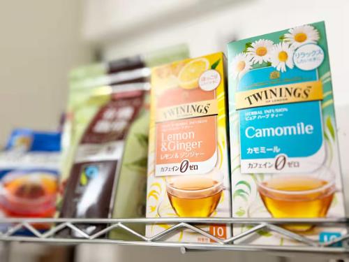 a shelf in a store with some cups of coffee at 女性専用ゲストハウス与那原 in Yonabaru