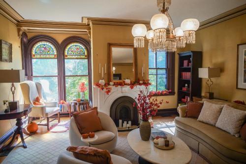 a living room with a fireplace and a chandelier at The Underwood-Hale House in Providence