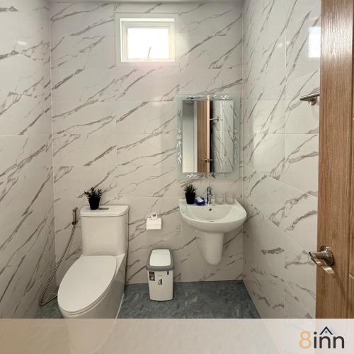 a white bathroom with a toilet and a sink at 8inn hostel 