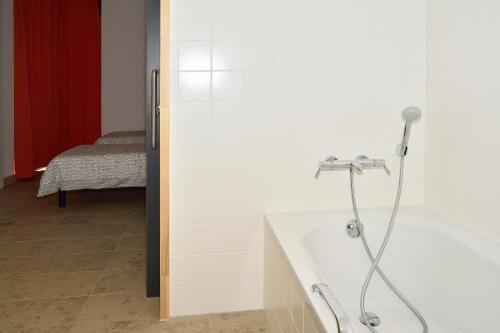 a shower in a room with a bath tub at Casa Ametza in Brasschaat
