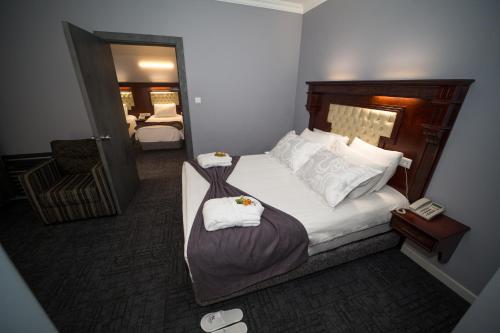 a bedroom with a bed with two towels on it at Funda Hotel in Trabzon