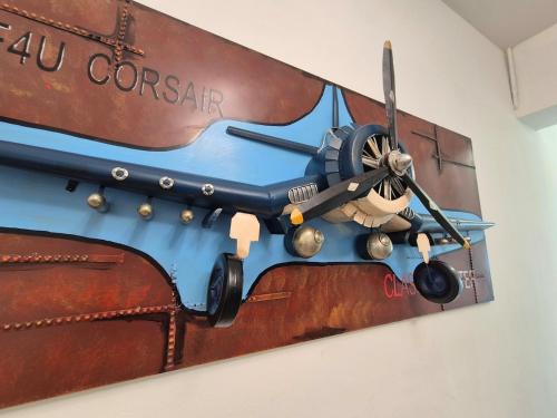 a model of an airplane hanging on a wall at Propeller Airplane Riverview Kuching Homestay in Kuching