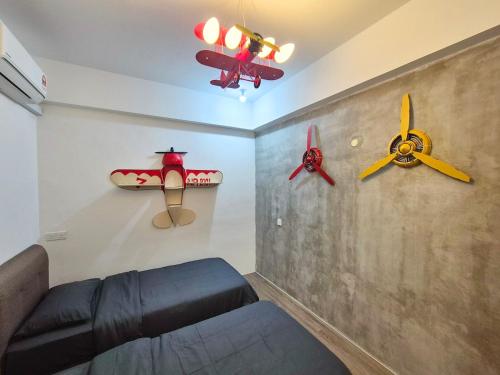 a living room with two ceiling fans and a couch at Propeller Airplane Riverview Kuching Homestay in Kuching