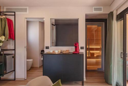 a bathroom with a counter with a red appliance on it at Camping Village Ekar Asiago in Asiago