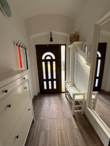 a room with a kitchen with a wooden floor and a door at Chata Pohoda Abertamy - Finská sauna in Abertamy
