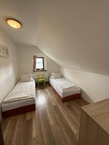a room with two beds and a window at Chata Pohoda Abertamy - Finská sauna in Abertamy