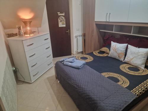a bedroom with a large bed and a dresser at Casa vacanze MARIA AMATO in Marsala